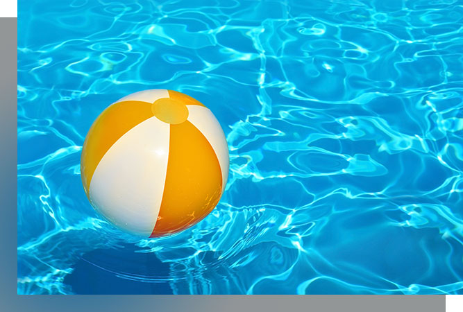 Beach ball floating in pool